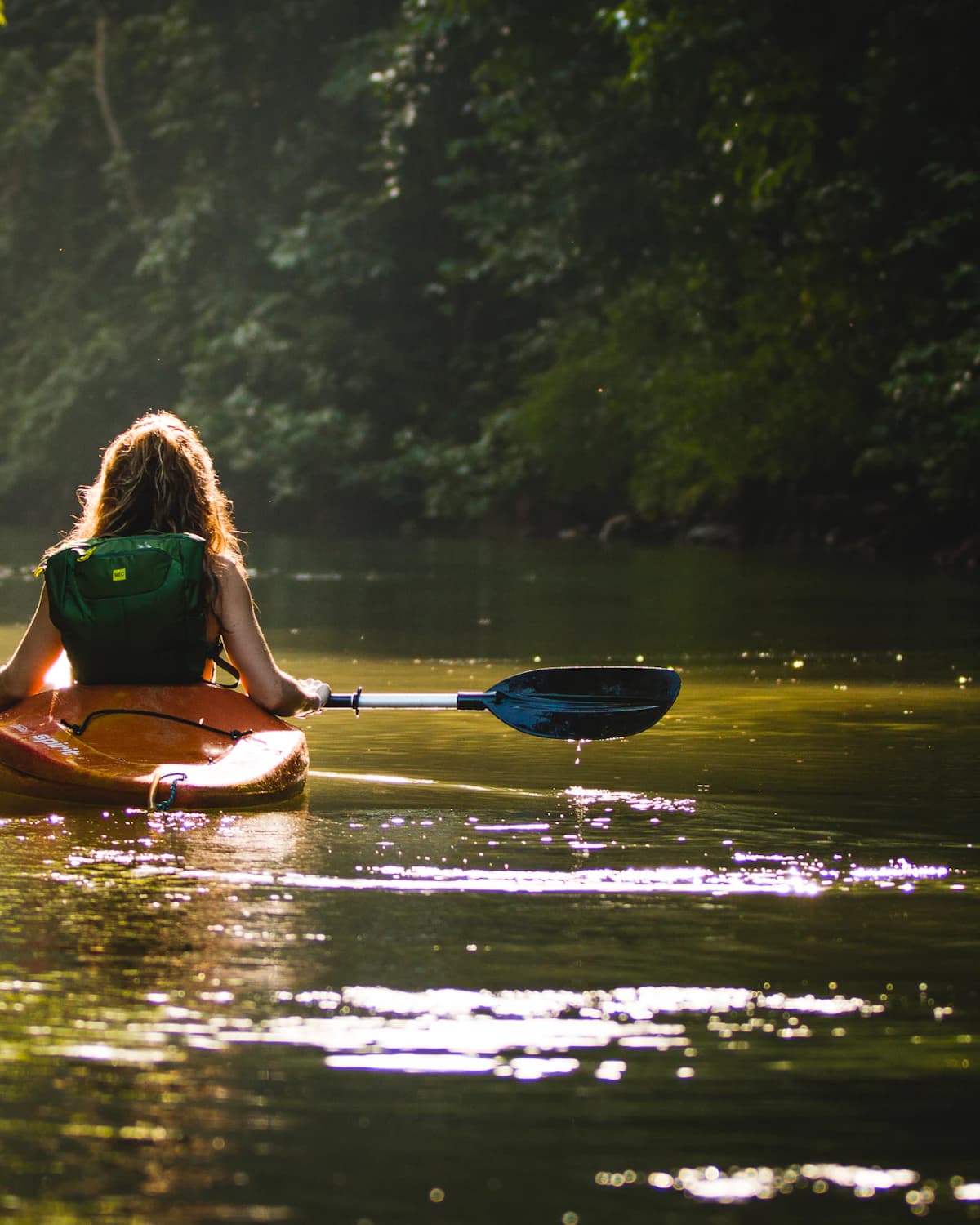 Kayaker paddling on open water